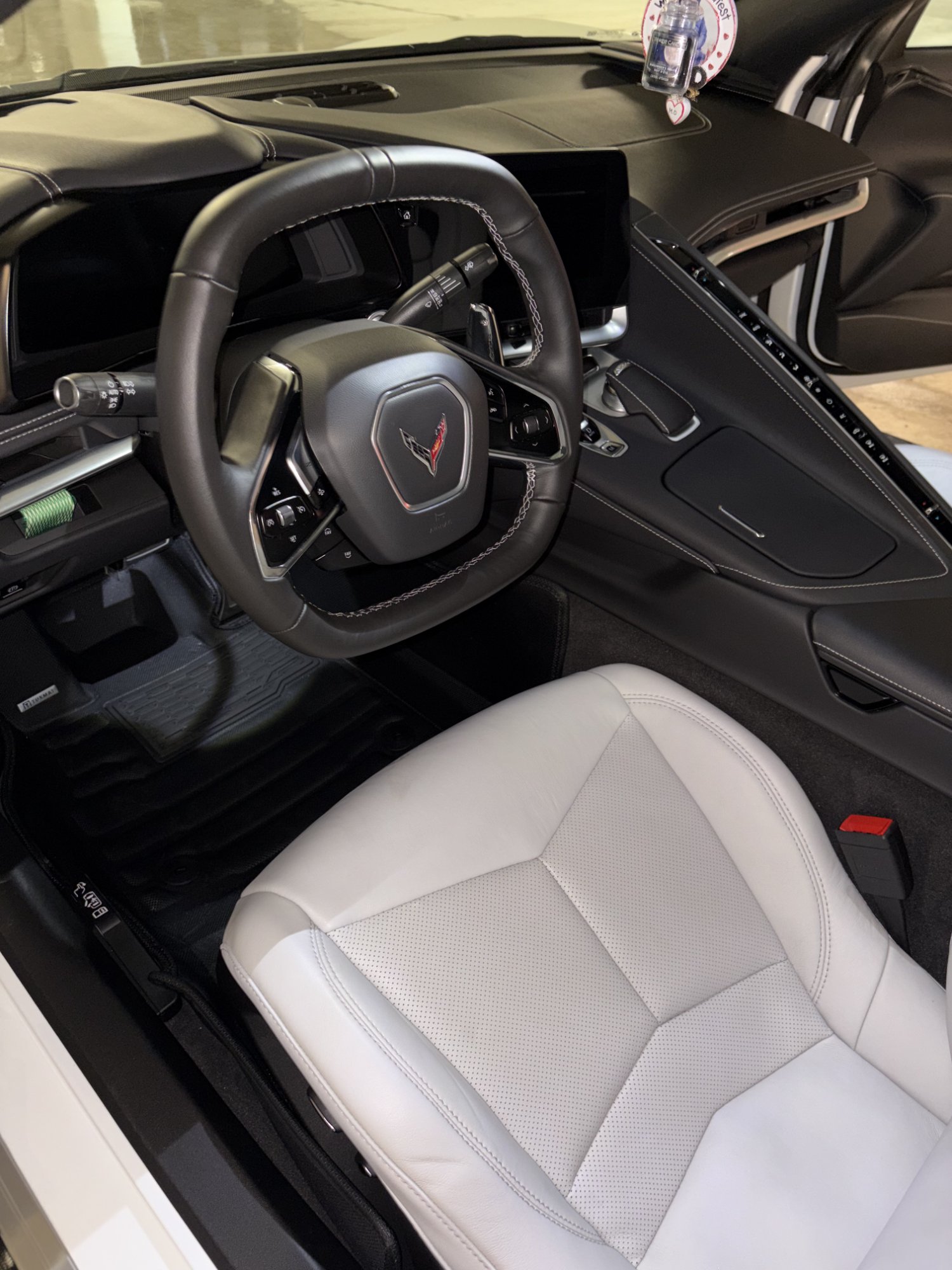 Corvette C8 interior detailing Burnaby — steering wheel and white leather seats cleaned