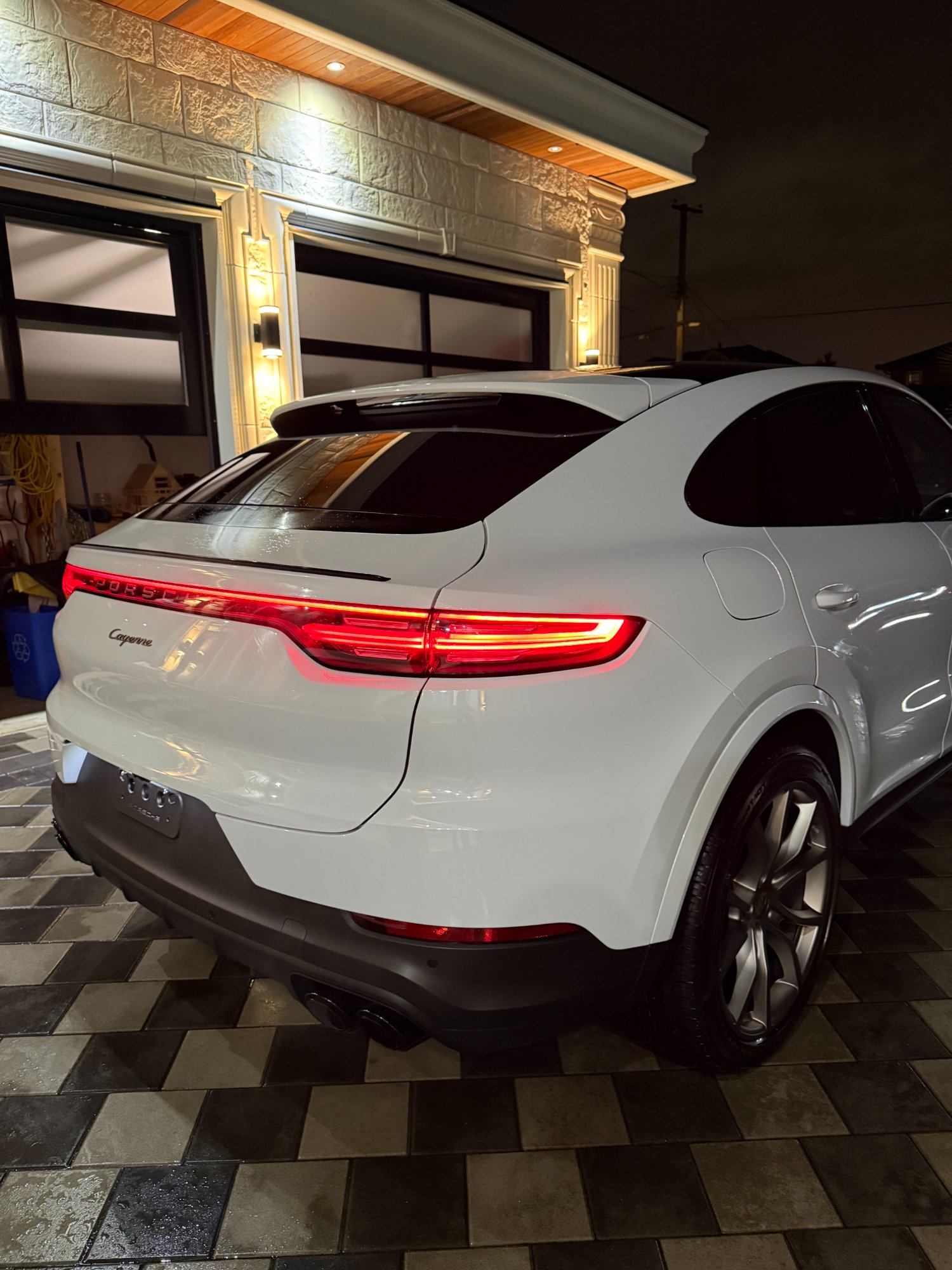 Porsche Cayenne Coupe rear exterior detail — exhaust and taillight after ceramic coating