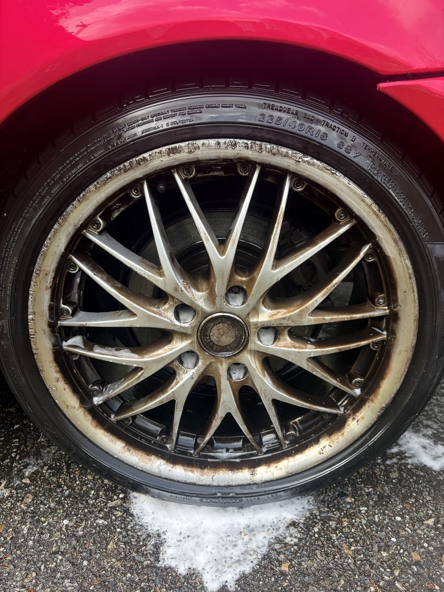 Before — BMW wheel covered in brake dust and grime